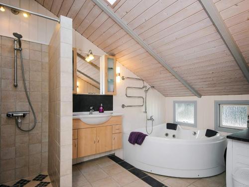 a bathroom with a large tub and a sink at 8 person holiday home in Sydals in Neder Lysabild
