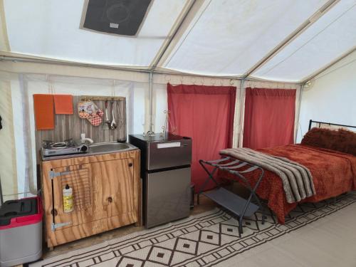 a room with a bed and a sink in a tent at Starlit Jasmine in Christiansted