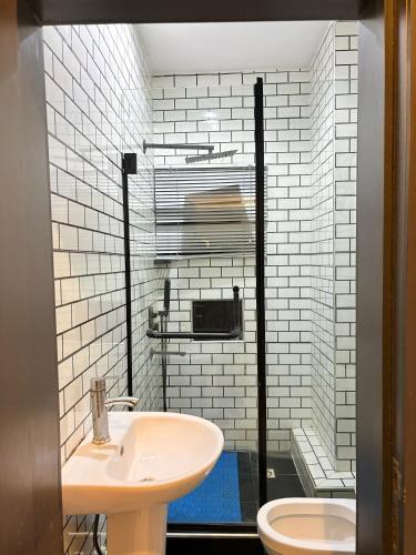 a bathroom with a sink and a toilet at Candy horizon height homes in Ikate
