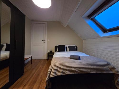 a bedroom with a large bed in a attic at Peaceful Pad in Brussels