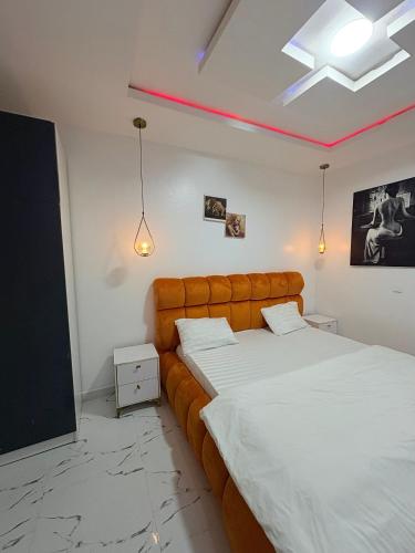 a bedroom with two beds and a flat screen tv at Candy horizon height Apartemnt in Ikate