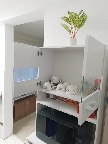 a kitchen with white cabinets and a stove top oven at Residencia Multifamiliar Sammy in Trujillo