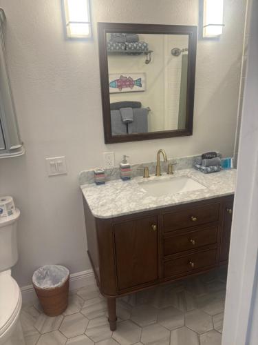 a bathroom with a sink and a mirror at Seaside Retreat Cottages #1 in Clearwater Beach