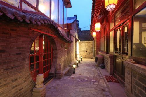 an alley in an old town at night at The Great Wall Courtyard Hostel in Yanqing