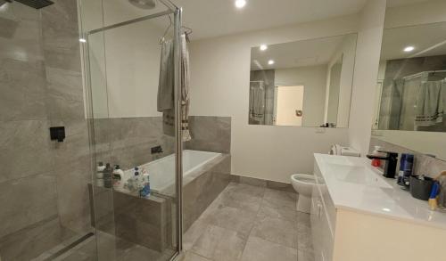 a bathroom with a shower and a sink and a toilet at Doncaster Westfiled House 4BD in Doncaster