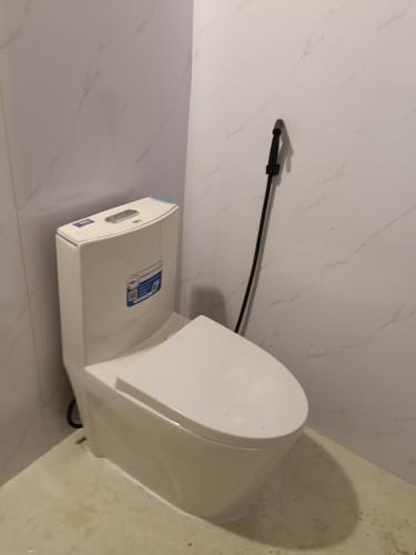 a bathroom with a white toilet in a room at Puluongholiday homestay2 in Làng Chiêu