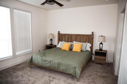 a bedroom with a bed with two yellow pillows at Rural Farmhouse in Taylor