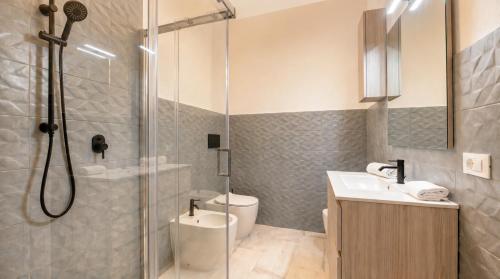 a bathroom with a shower and a toilet and a sink at Dimoras Central Studio 4 Guests Parking in Olbia