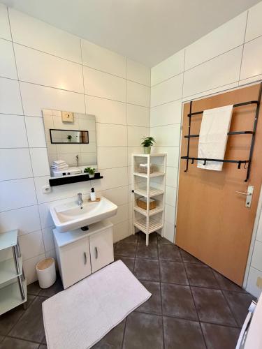 a bathroom with a sink and a mirror at Traunzeit Apartment in Ebensee