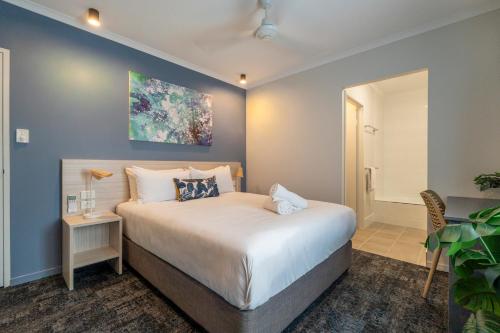 a bedroom with a large bed in a room at Cairns Southgate Hotel in Cairns