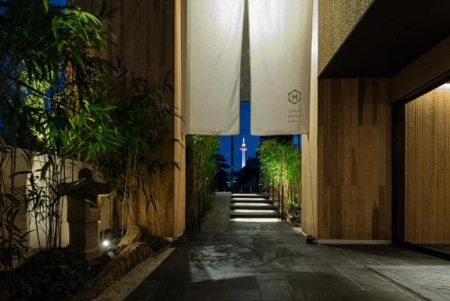an empty hallway with plants on the side of a building at hotel kanra kyoto in Kyoto