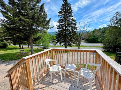 two chairs and a table on a wooden deck at Tiny Home Topline in Carroll