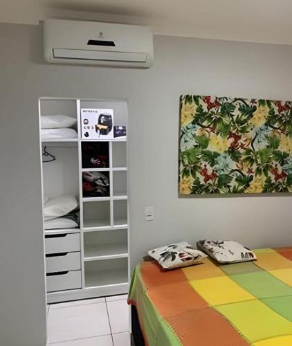 a bedroom with a bed and a closet at Residencial Villa dos Corais - Staybeach in Porto Seguro
