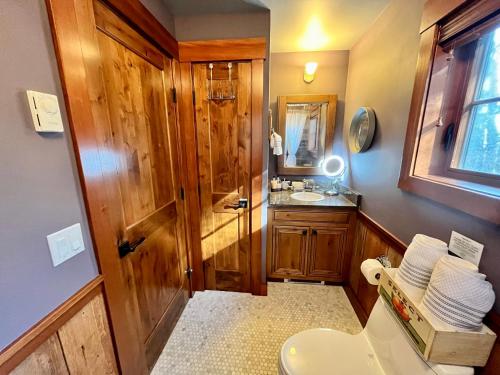 a bathroom with a toilet and a sink at Beach Kayaks Hot Tub Private Cottage in Friday Harbor