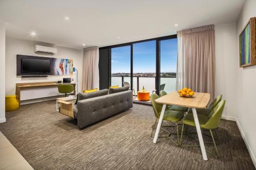 a living room with a couch and a table at Quest Dandenong Central in Dandenong