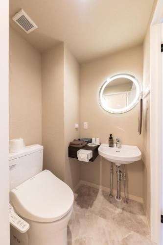 a bathroom with a toilet and a sink at Business Hotel Hayashiso in Miyazaki