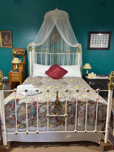 a bedroom with a large bed with a canopy at Bethany Cottages in Bethany