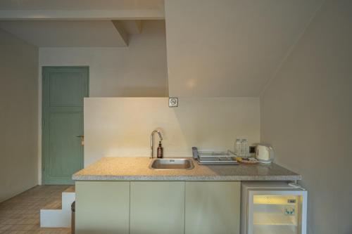 a kitchen with a sink and a counter top at Studio O - Two-Floor Studio, Walk to the Beach in Seminyak