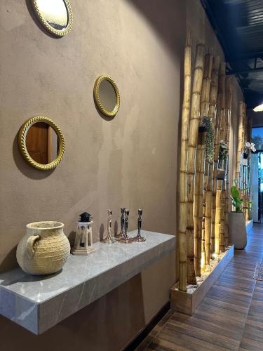 a counter with glasses and mirrors on a wall at Doña Emilia Hotel Boutique in Villarrica