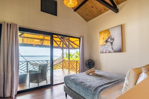 a bedroom with a bed and a view of the ocean at La Brisa del Mar in Bastimentos