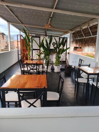 a restaurant with tables and chairs on a roof at HOUSSE 69 Café Bar in Satipo