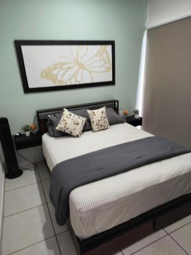a bedroom with a bed with two pillows on it at Depa Colón in Mazatlán