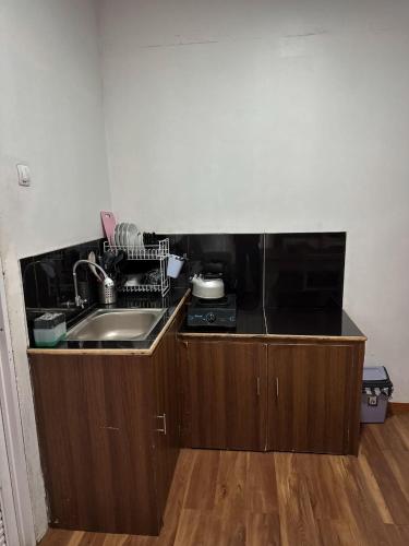 a kitchen with a sink and a counter top at Villa Dieng Sikapuk Hill Superior Cabin in Kejajar