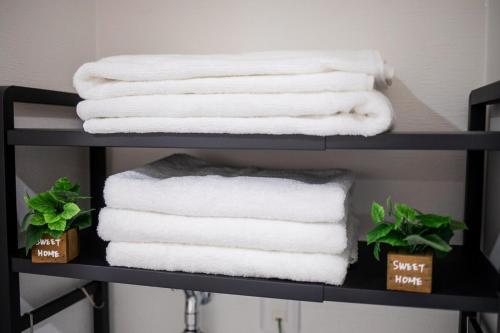 a stack of towels on a shelf with towels at Lucky Today in Osaka