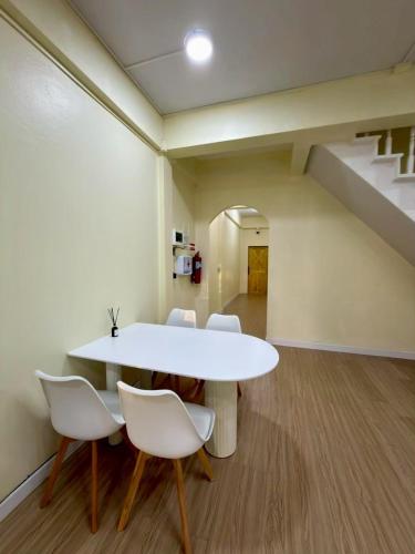 a dining room with a white table and chairs at Caesar's Corner 2 Bedroom House in Ban Lak Roi