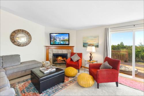 a living room with a couch and chairs and a fireplace at Ocean Front Clamming Game Room Large Deck in Ocean Shores