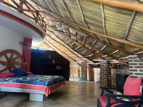 a bedroom with a bed and a wooden ceiling at Condominio La Palapa in Bucerías