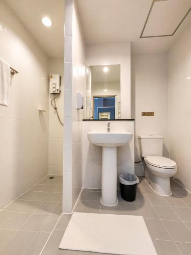 a bathroom with a sink and a toilet at The Fifth Residence in Bangkok