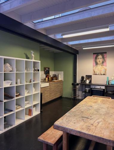 a large room with a table and a shelf at Funky artists studio in Paris in Pantin