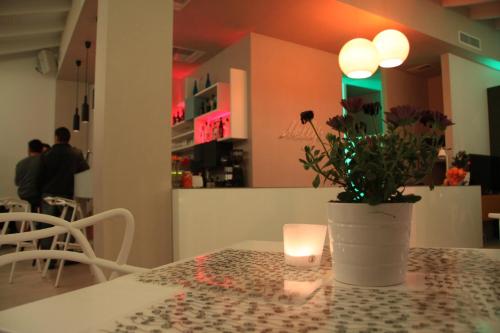 a table with a candle and a vase with flowers on it at Nelly's Apartments in Tolo
