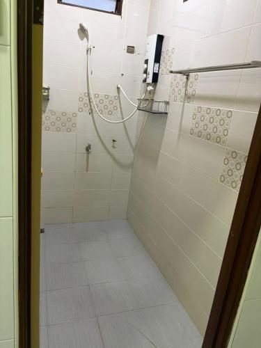 a shower with a glass door in a bathroom at De JITRA 2 HOMESTAY in Jitra