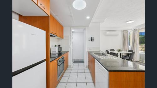 a kitchen with a counter top and a table at Palazzo Colonnades in Gold Coast