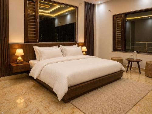 a bedroom with a large bed and a large window at The Tranquil hotel in Chakrāta