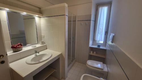 a bathroom with a sink and a toilet and a mirror at B&B la Giorgetta in Pozzolo Formigaro