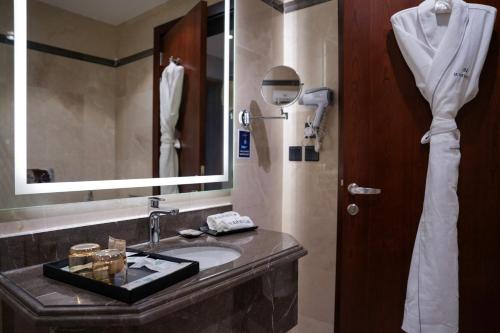 a bathroom with a sink and a mirror at Warwick Hotel Al Safa - Jeddah in Jeddah