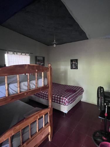 a bedroom with two bunk beds and a window at Punta Roca Surf House in El Majahual