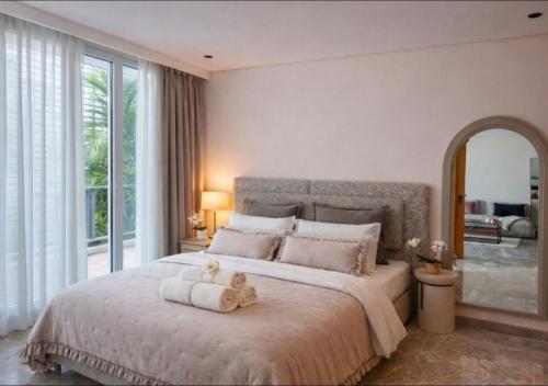 a bedroom with a bed with two teddy bears on it at Auralys Seaside Studio avec balcon in Casablanca