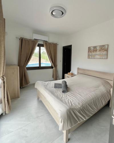 a bedroom with a bed with a cat on it at Villa Terra Rosa in Kritou Terra