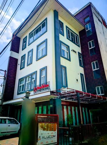 a building with a sign in front of it at Hotel Roselle inn in Jāmb