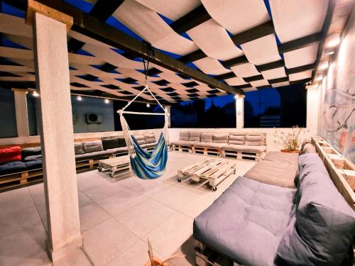 a room with a hammock and chairs on a boat at Backpackers Home in Zadar