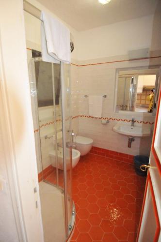 a bathroom with a shower and a toilet and a sink at Residence Cala Di Mola in Porto Azzurro