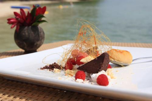 a plate of food with strawberries on a table at Erakor Island Resort & Spa in Port Vila