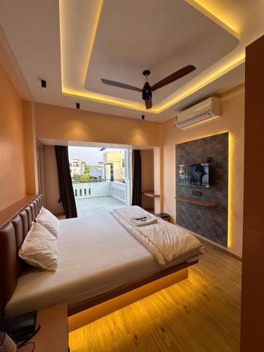 a bedroom with a large bed with a fireplace at Hotel Vyankatesh Inn in Nashik