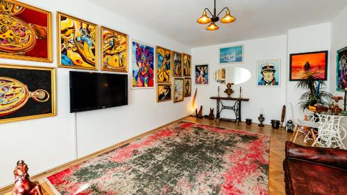 a living room with a flat screen tv on a wall at Central Art Apartment with Treasure Hunt, Free Parking & Self Check-In in Constanţa