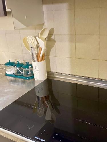 a kitchen counter with a utensil holder on top of a stove at Pescasseroli Home in Pescasseroli
