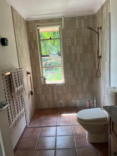 a bathroom with a toilet and a window at Bexhill Grace in Lismore